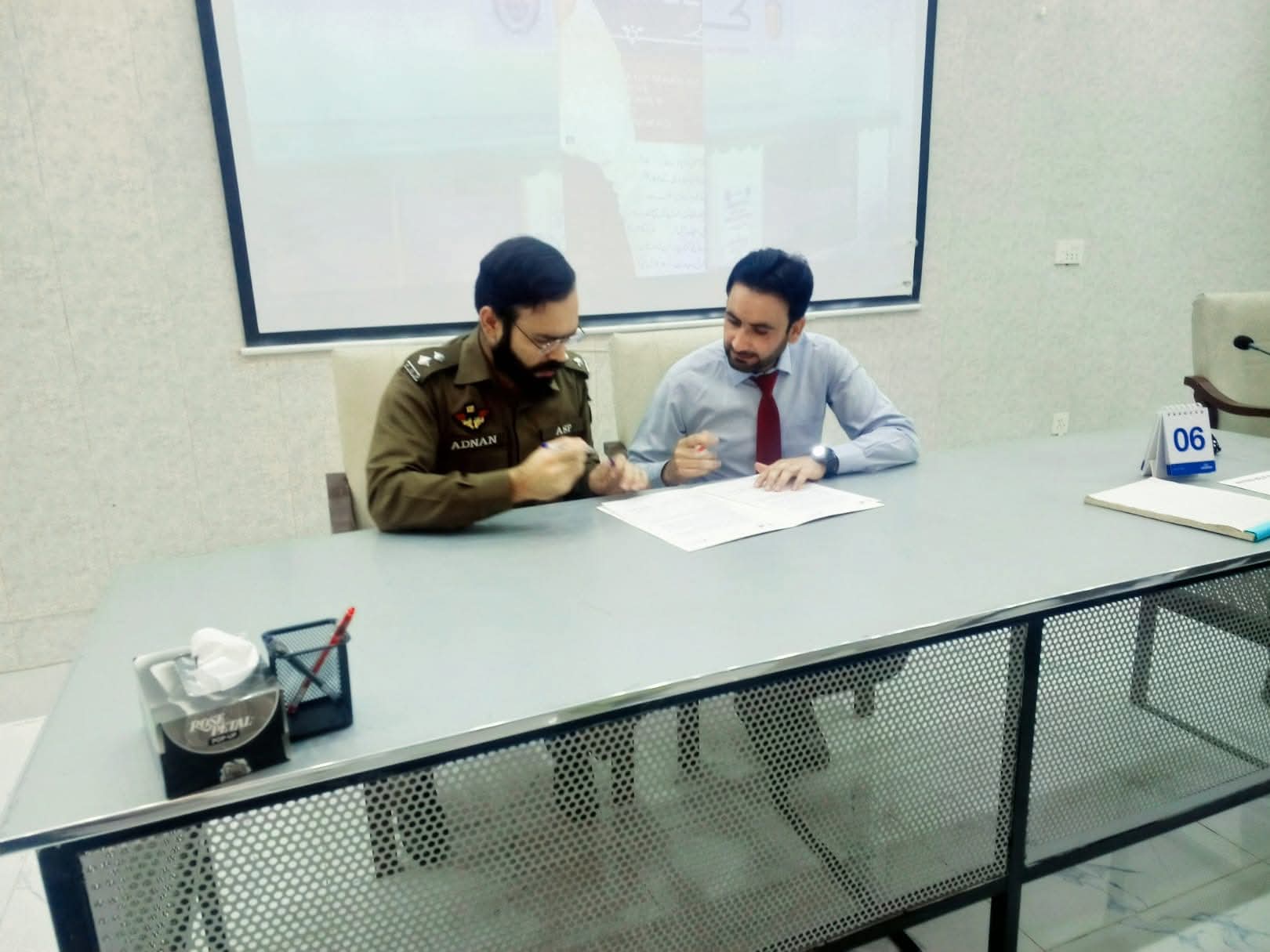 Al-Nisa representative signing MOU with ASP Adnan